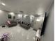 Open-concept living room with white floors, stylish lighting, and cozy furnishings at , Las Vegas, NV 89104