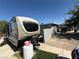 Parked RV featuring external gas hookups, a synthetic turf landing, and rear neighbor privacy fence at , Las Vegas, NV 89104