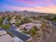 Scenic aerial view of a luxury home nestled in a beautiful community with mountain views at sunset at 1 Dry Brook Trl, Henderson, NV 89052