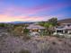 Elevated view showcasing a home with pool, outdoor living space, and stunning mountain and desert views at 1 Dry Brook Trl, Henderson, NV 89052