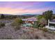 Expansive aerial view of the property featuring a luxurious pool, landscaping, and mountain views in the distance at 1 Dry Brook Trl, Henderson, NV 89052
