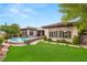 Stunning backyard features a modern pool and lush green lawn with scenic views at 1 Dry Brook Trl, Henderson, NV 89052