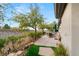 Backyard patio featuring a dining area with desert views and lush landscaping at 1 Dry Brook Trl, Henderson, NV 89052