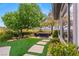 Relax in this backyard patio with an outdoor seating area surrounded by lush landscaping at 1 Dry Brook Trl, Henderson, NV 89052