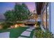 Cozy backyard space with an outdoor seating area, manicured lawn, and mature trees at 1 Dry Brook Trl, Henderson, NV 89052