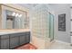 Stylish bathroom with a glass block shower and a double vanity, offering a modern design at 1 Dry Brook Trl, Henderson, NV 89052