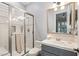 Clean bathroom with glass shower, white tile, and modern fixtures and vanity at 1 Dry Brook Trl, Henderson, NV 89052