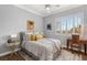 Bright bedroom with shutters features a ceiling fan, neutral walls and comfortable furnishings at 1 Dry Brook Trl, Henderson, NV 89052