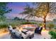Inviting outdoor fire pit area with comfortable seating, perfect for relaxing and enjoying the serene surroundings at 1 Dry Brook Trl, Henderson, NV 89052