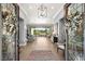 Spacious foyer showcases light wood floors and views of the outdoor space through decorative glass doors at 1 Dry Brook Trl, Henderson, NV 89052