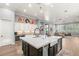 Open-concept kitchen with hardwood floors, large island, and views into living room at 1 Dry Brook Trl, Henderson, NV 89052
