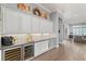 Gourmet kitchen area with a wine refrigerator and custom cabinets, perfect for entertaining guests at 1 Dry Brook Trl, Henderson, NV 89052