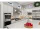 Modern kitchen with granite countertops, stainless steel appliances, and custom cabinetry at 1 Dry Brook Trl, Henderson, NV 89052