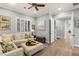 Comfortable living room with a plush sofa, plantation shutters, and a welcoming atmosphere at 1 Dry Brook Trl, Henderson, NV 89052