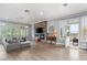 Bright open living room with doors to patio with mountain view, fireplace, and hardwood floors at 1 Dry Brook Trl, Henderson, NV 89052