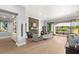Bright living room featuring a modern fireplace, elegant furnishings, and seamless access to the backyard pool at 1 Dry Brook Trl, Henderson, NV 89052