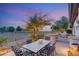 Backyard features an outdoor kitchen with stone counter, grill, sink, and a dining area for outdoor enjoyment at 1 Dry Brook Trl, Henderson, NV 89052