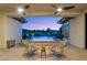 Inviting outdoor patio with stylish seating overlooking the pool and peaceful landscape at sunset at 1 Dry Brook Trl, Henderson, NV 89052