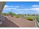 A spacious, landscaped backyard area with stone ground cover and wrought iron railing at 10700 Button Willow Dr, Las Vegas, NV 89134