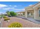Home's backyard with desert landscaping, patio, and beautiful surrounding greenery at 10700 Button Willow Dr, Las Vegas, NV 89134