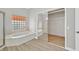 Bathroom featuring a soaking tub and a large closet with mirrored doors at 10700 Button Willow Dr, Las Vegas, NV 89134