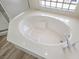 Soaking tub with marble surround and tiled shower at 10700 Button Willow Dr, Las Vegas, NV 89134