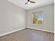 Bedroom featuring a window, base trim, ceiling fan, and hard surface floors at 10700 Button Willow Dr, Las Vegas, NV 89134