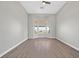 Bright bedroom with a large window offering stunning views and luxury vinyl flooring at 10700 Button Willow Dr, Las Vegas, NV 89134