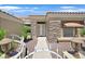 A welcoming front entrance with stone accents, double doors, and decorative iron gate at 10700 Button Willow Dr, Las Vegas, NV 89134