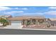 Charming single-story home featuring a well-manicured front yard, tiled roof, and a two-car garage at 10700 Button Willow Dr, Las Vegas, NV 89134