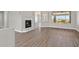 A bright living space featuring a fireplace, hard flooring, and views through a large window at 10700 Button Willow Dr, Las Vegas, NV 89134