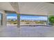 Spacious covered patio with a beautiful view of the mountains and surrounding landscape at 10700 Button Willow Dr, Las Vegas, NV 89134