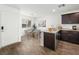 A well-lit kitchen dining space features dark cabinets, granite countertops, and stainless appliances at 12112 Polar White Ct # 3, Las Vegas, NV 89183