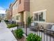 A patio with seating and a black metal fence provides an inviting outdoor living space at 12112 Polar White Ct # 3, Las Vegas, NV 89183