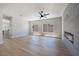 Inviting living area featuring wood-look floors, an electric fireplace and seamless kitchen access at 1312 Pacific Terrace Dr, Las Vegas, NV 89128