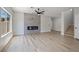 Cozy living room with electric fireplace, wood-look floors, and staircase access at 1312 Pacific Terrace Dr, Las Vegas, NV 89128