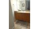 Bright bathroom features a large mirror, oak cabinets, and a granite countertop at 1515 E Reno Ave # D202, Las Vegas, NV 89119