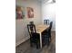 Bright dining area featuring a wood table and black chairs at 1515 E Reno Ave # D202, Las Vegas, NV 89119