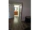 Hallway leading to bathroom with wood cabinets and mirror at 1515 E Reno Ave # D202, Las Vegas, NV 89119