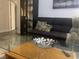 Stylish living room with leather sofa, glass coffee table and dark wood accents at 1515 E Reno Ave # D202, Las Vegas, NV 89119