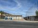 A single-story home with a fenced yard, showing a view from the street and nearby foliage at 1713 Fairfield Ave, Las Vegas, NV 89102