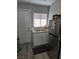 Compact kitchen featuring white cabinets, a stainless steel fridge, and modern sink fixtures at 1713 Fairfield Ave, Las Vegas, NV 89102