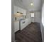 Bright kitchen with white cabinets and appliances, contrasted by dark wood look floors at 1713 Fairfield Ave, Las Vegas, NV 89102