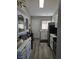 Efficient kitchen space with white cabinets, modern appliances, and updated flooring at 1713 Fairfield Ave, Las Vegas, NV 89102