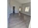 Living room featuring gray wood look floors, white trim, and natural light at 1713 Fairfield Ave, Las Vegas, NV 89102