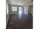 Bright living room featuring wood look floors, a window, and a view of the front door at 1713 Fairfield Ave, Las Vegas, NV 89102