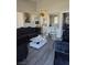 Modern living room showcasing dark furniture, white accents, and a glimpse into the kitchen at 1713 Fairfield Ave, Las Vegas, NV 89102