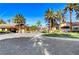 Community entrance with lush landscaping, mature palm trees, and well maintained grounds at 2050 W Warm Springs Rd # 4512, Henderson, NV 89014