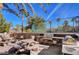 A community grill area with picnic tables, barbecue, and views of the tennis courts at 2050 W Warm Springs Rd # 4512, Henderson, NV 89014