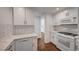 Beautiful kitchen with updated cabinets, white countertops, and stainless steel appliances at 2050 W Warm Springs Rd # 4512, Henderson, NV 89014